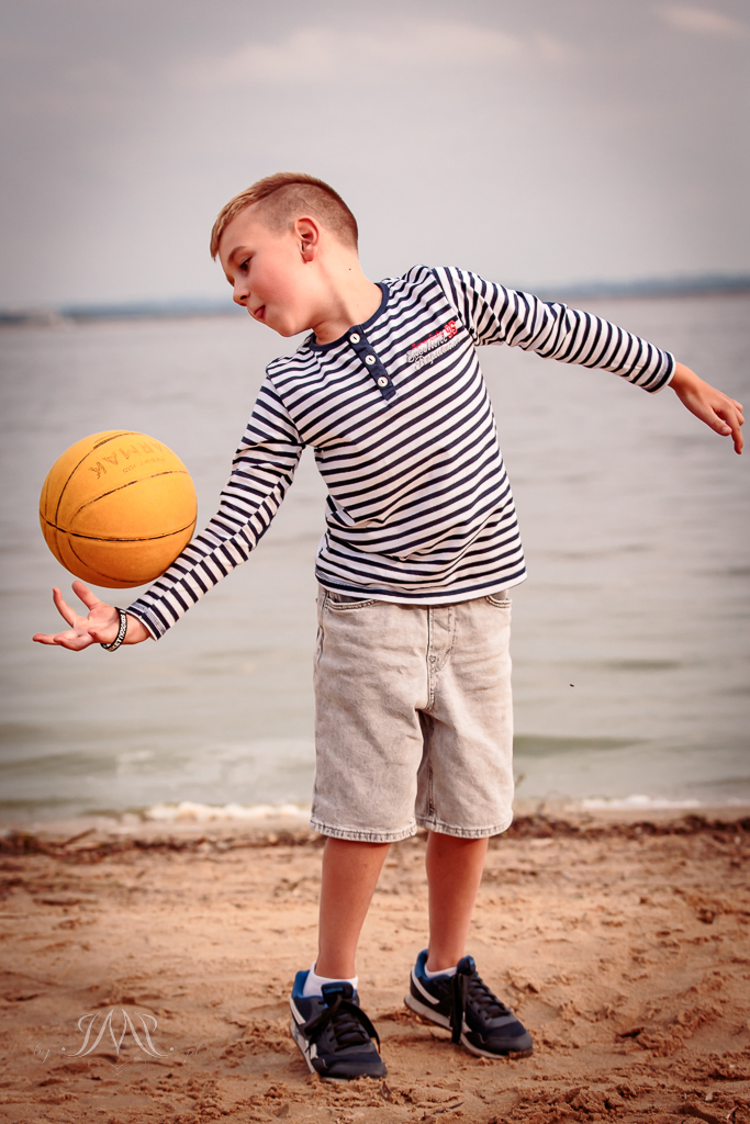 chłopiec rzuca piłką do koszykówki